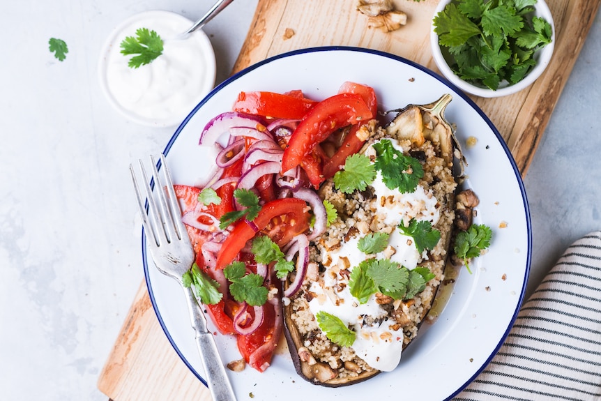 Stuffed eggplants with youghurt and salad on a table