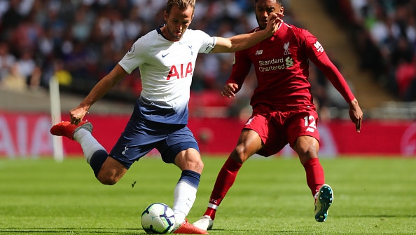 Tottenham Hotspur striker Harry Kane (left) prepares to shoot