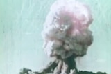 A mushroom cloud rises from the desert of Maralinga after a nuclear weapons test.