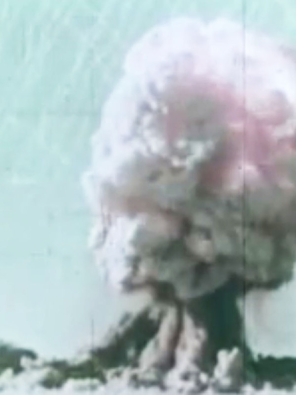 A mushroom cloud rises from the desert after a nuclear blast