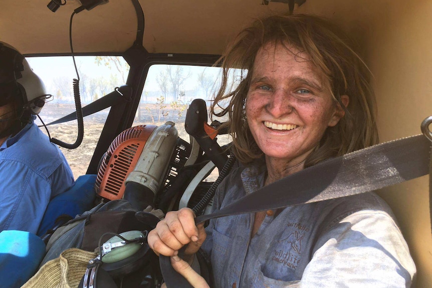 Ecologist Rosie Honen, from Australia Wildlife Conservancy returns from a helicopter survey, covered in dust and ash.
