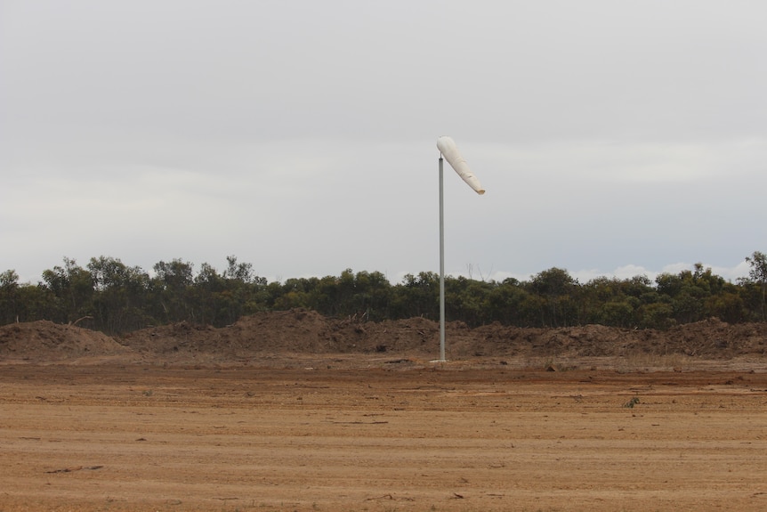 A white windsock on the new airstrip