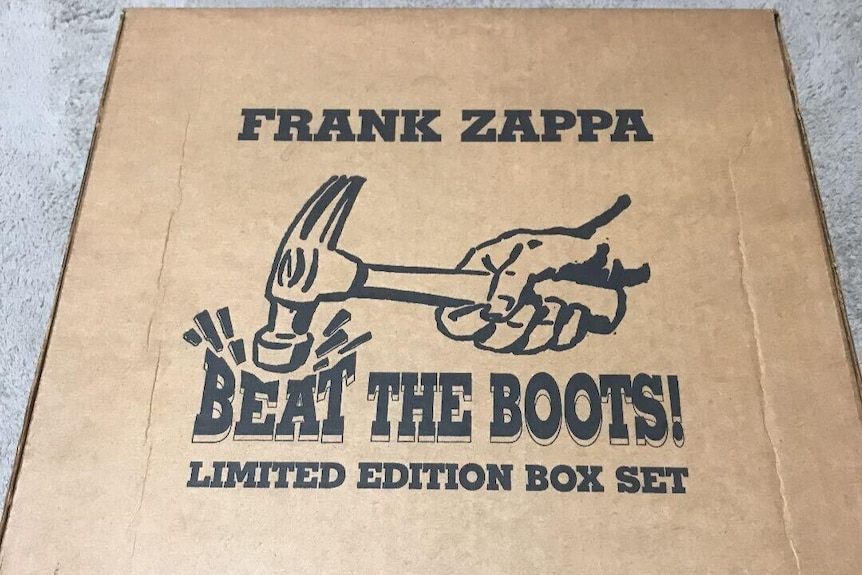 a picture of a cardboard box with 'Frank Zappa' written on it. 