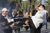 Protesters clash with police in political riots that erupted in the capital Tunis