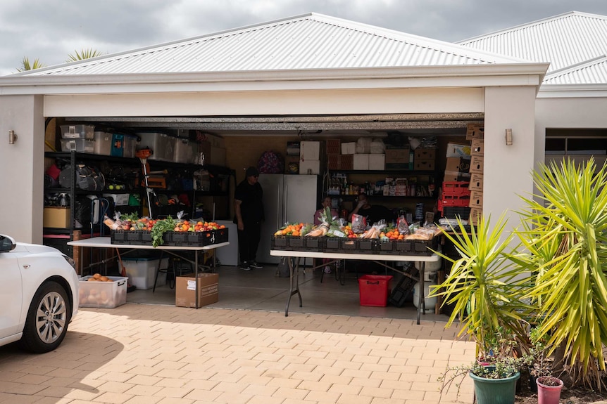 Garage with door up and food set out on tables inside