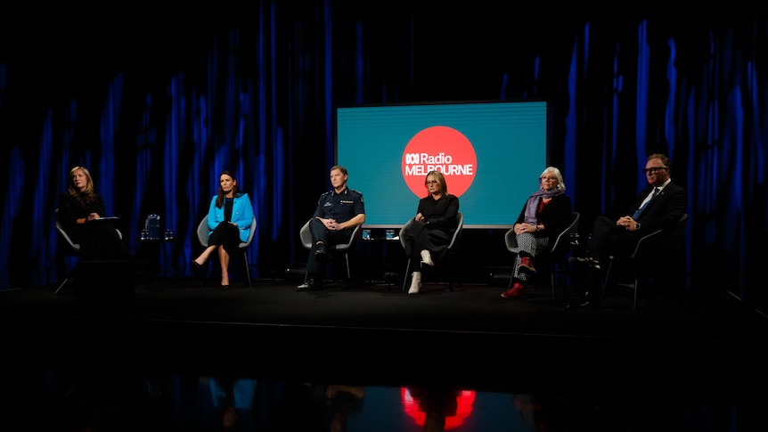 A panel of people sitting in chairs in a TV studio