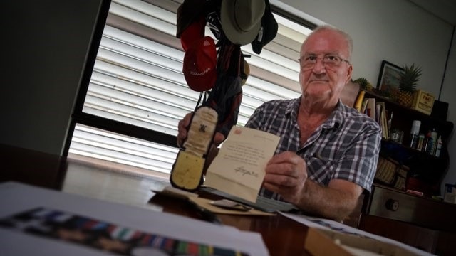 Bob Elcoate holds empty war medals belonging to his father C.J.