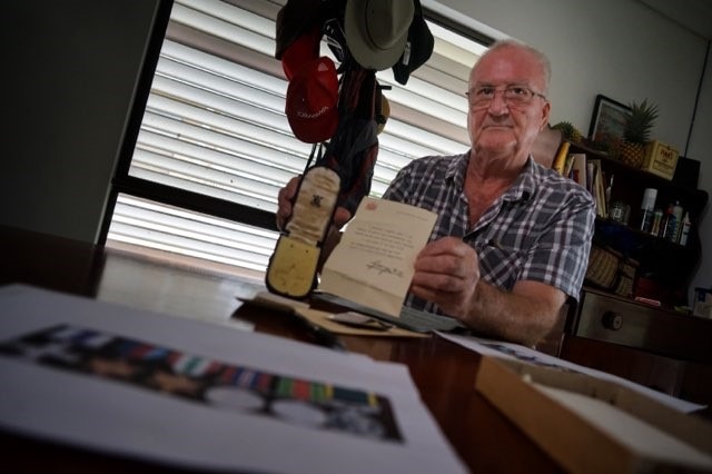 Bob Elcoate holds empty war medals belonging to his father C.J.