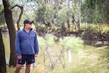 Farmer Shawn Fresser stands next to the Condamine River.