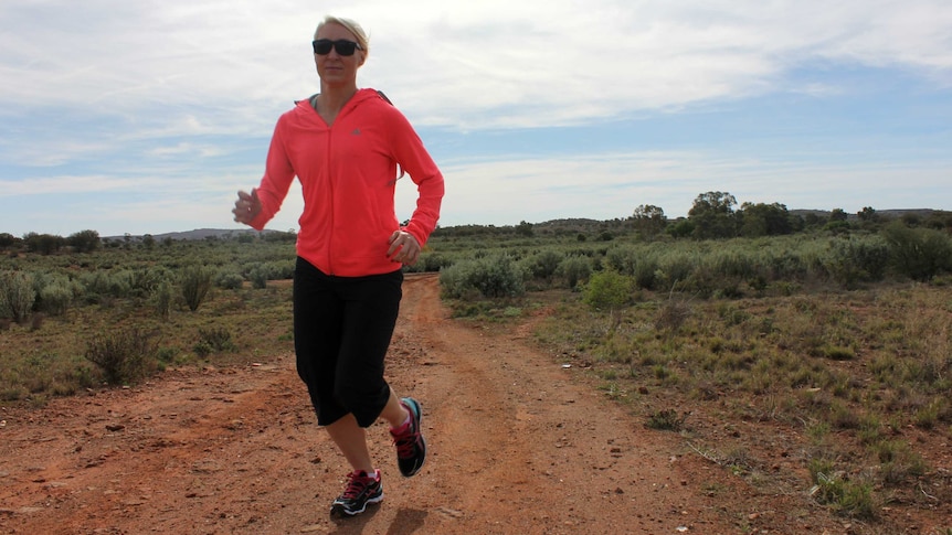 Fitness instructor and registered nurse, Jacque Ogilvy, jogs through the Broken Hill scrub.
