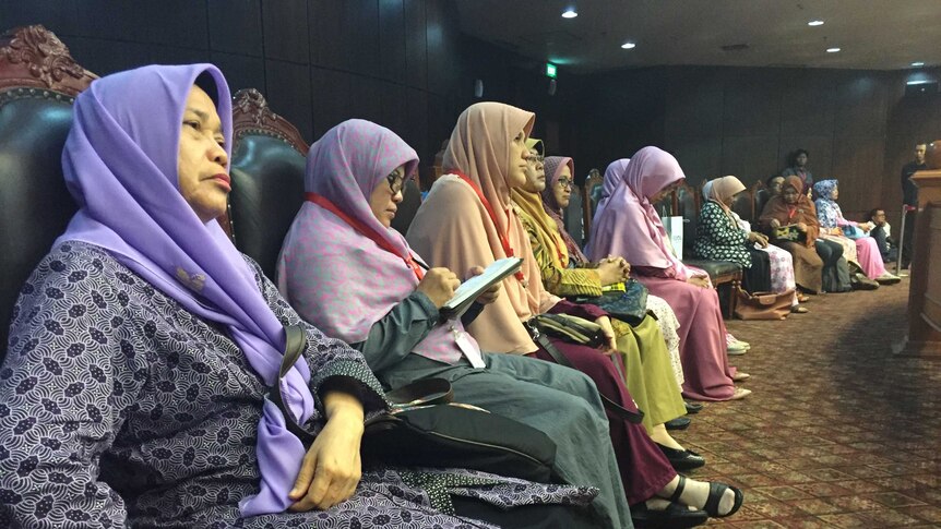 Members of the Family Love Alliance sitting in a row wearing colourful hijabs, at the Constitutional Court in Jakarta.