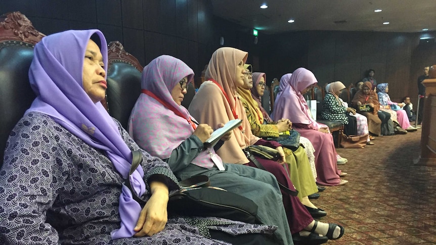 Members of the Family Love Alliance sitting in a row wearing colourful hijabs, at the Constitutional Court in Jakarta.