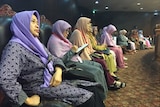 Members of the Family Love Alliance sitting in a row wearing colourful hijabs, at the Constitutional Court in Jakarta.