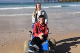 Julie's children on a beach in a story about affordable travel ideas that aren't camping.