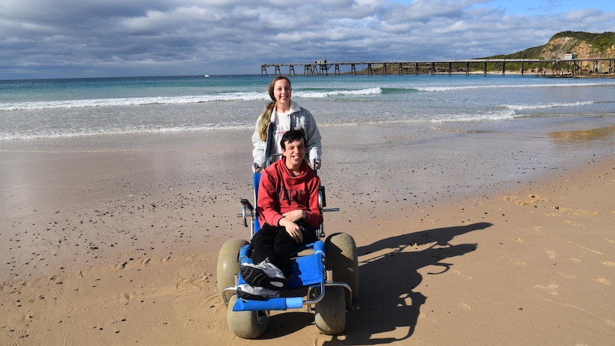 Julie's children on a beach in a story about affordable travel ideas that aren't camping.