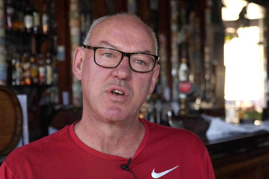 A man in a red tshirt in a pub