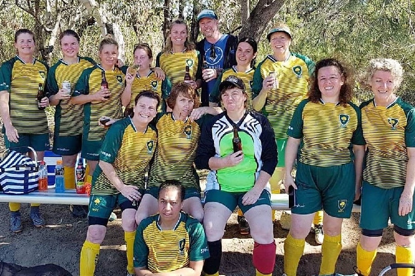 A group of women wearing green and yellow football kit