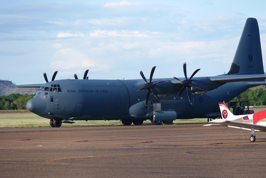 Image of an RAAF hercules sitting on a remote runway.