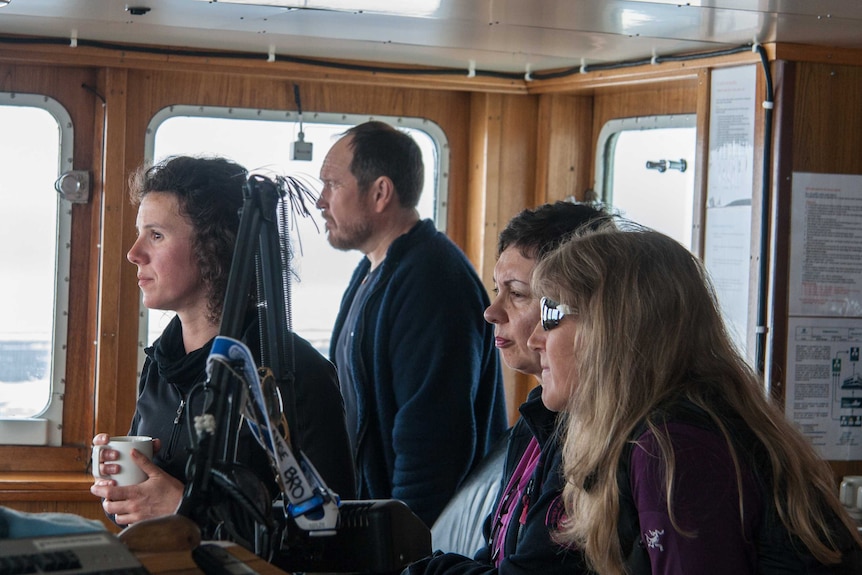 Amelie Meyer and crew in the cockpit of a ship.