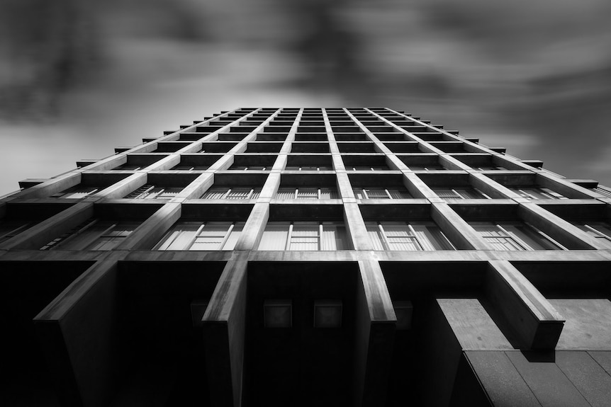 a concrete building photographer from the ground looking up