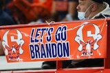 A sign reading "Let's go Brandon" is displayed on the railing in the first half of an NCAA college football game