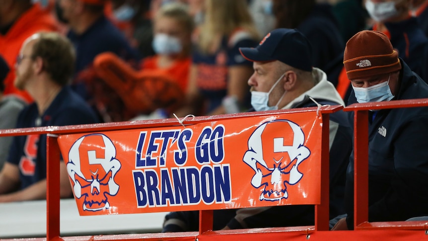 A sign reading "Let's go Brandon" is displayed on the railing in the first half of an NCAA college football game