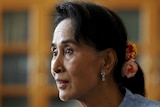 Aung San Suu Kyi speaks to reporters in her Myanmar office on April 3, 2015