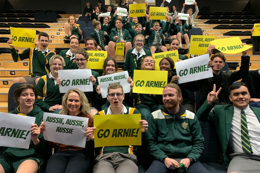 Students at St Patrick's College in Launceston cheer on Ariarne Titmus