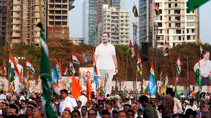A larger-than-life cutout of Rahul Gandhi stands tall among a crowd during his Bharat Jodo march in Mumbai. 