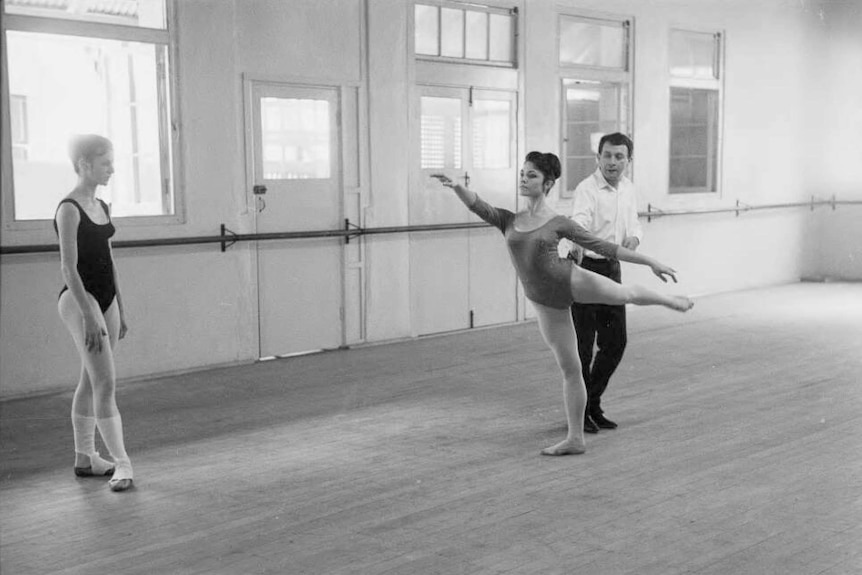 A black and white photo of Charles Lisner coaching a dancer.