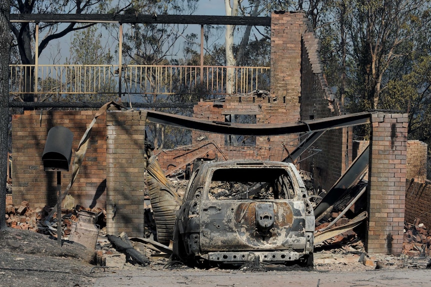 A home is seen completely destroyed after a devastating bushfire passed through at Winmalee in the Blue Mountains