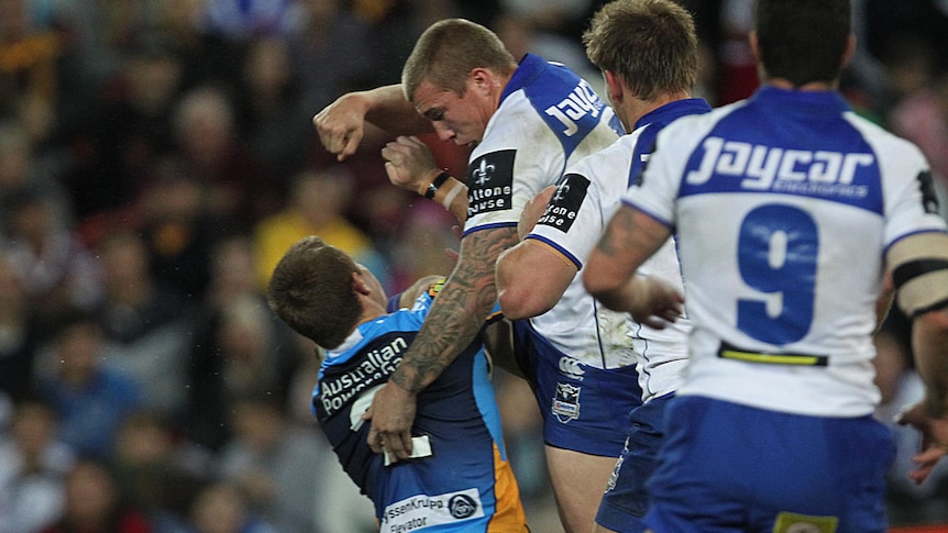 Laying down the law ... Trent Hodkinson lines up Titans winger Steve Michaels at Lang Park.