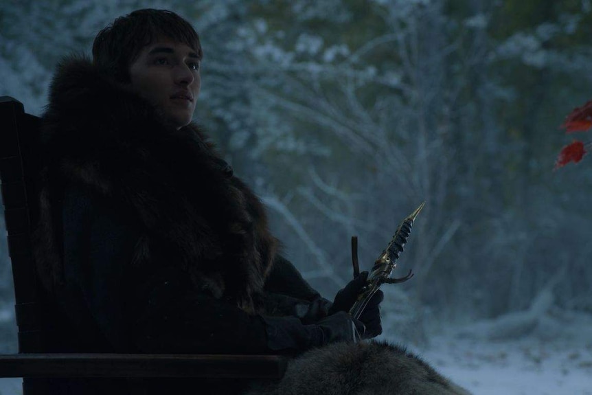 Bran holds the catspaw dagger while sitting in his wheelchair.