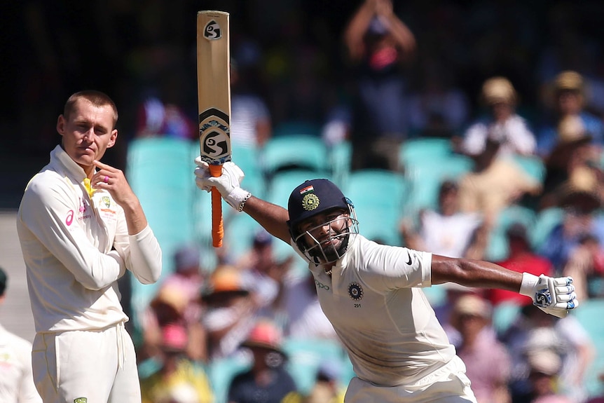 India batsman Rishabh Pant swings his bat in glee during a Test at the SCG. Marnus Labuschagne can't look. He turns away.