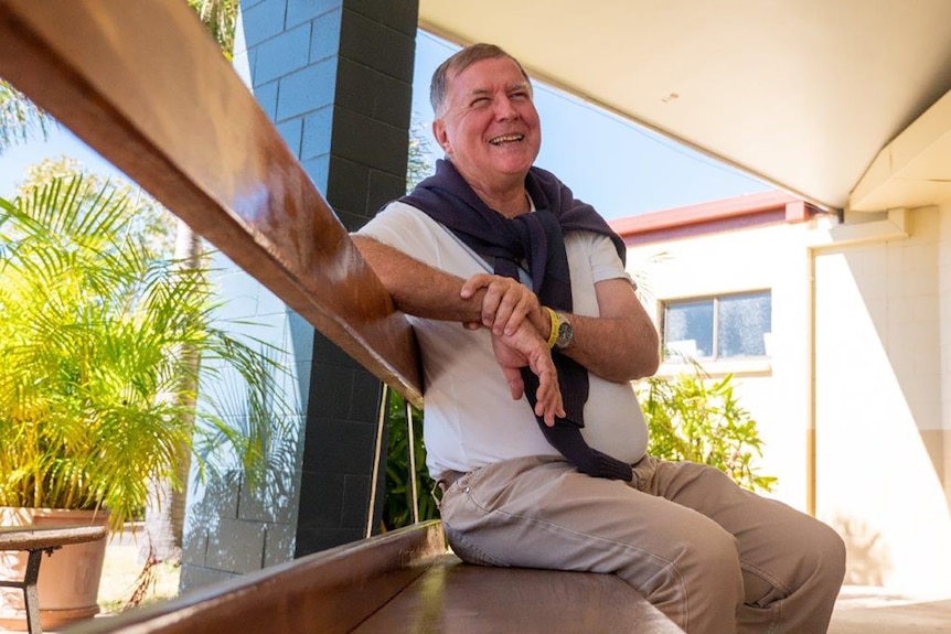 Father Mick on a bench in his church