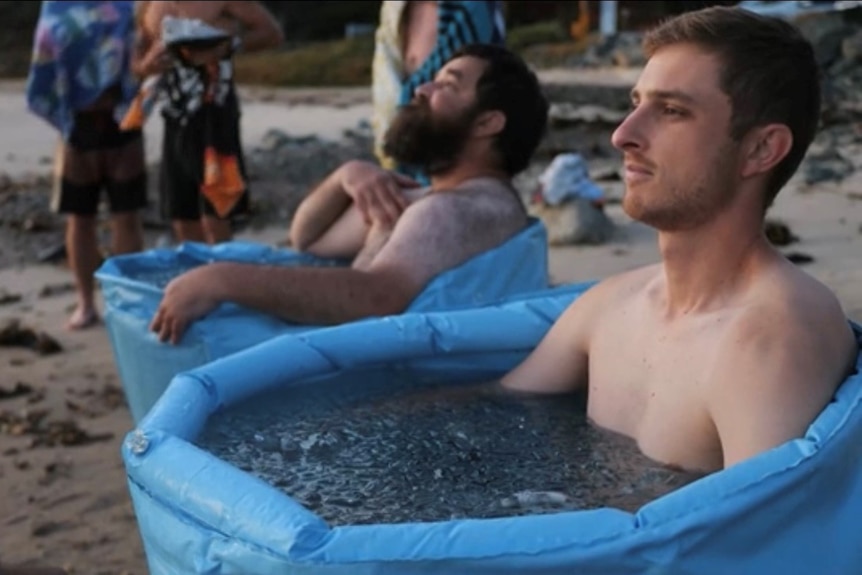 a few men soaking in ice baths at Shelly Beach in Port Macquarie
