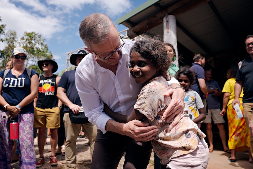 Anthony Albanese hugged by a child after Garma Festival 2023 speech