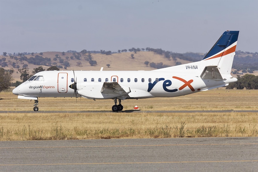 A Rex Airlines plane stands on a runway.