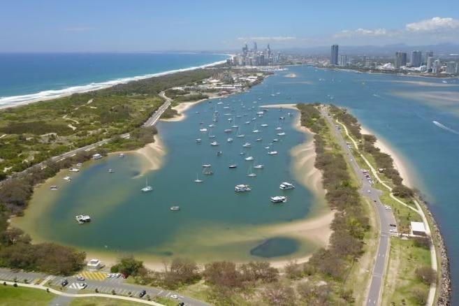 Over head shot of a sand spit with boats on the water