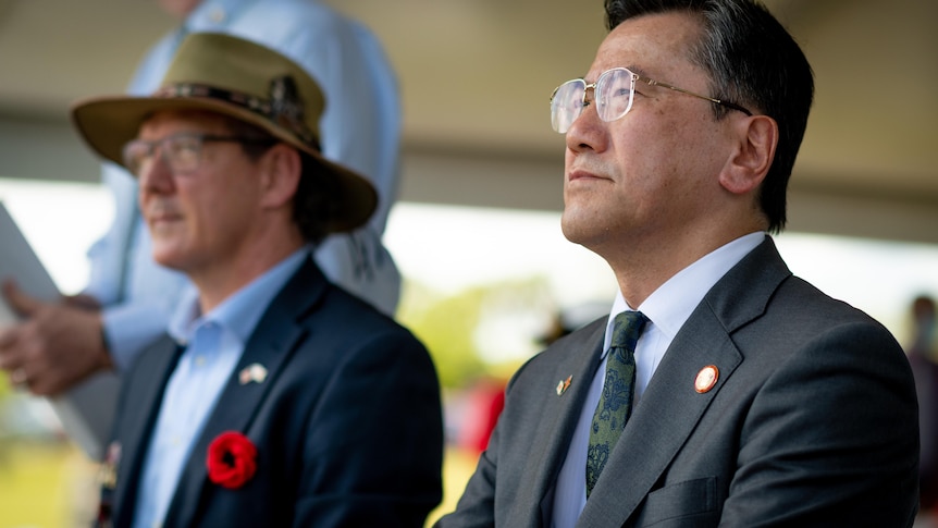 Shingo Yamagami and Michael Gunner sit next to each other at the memorial service.