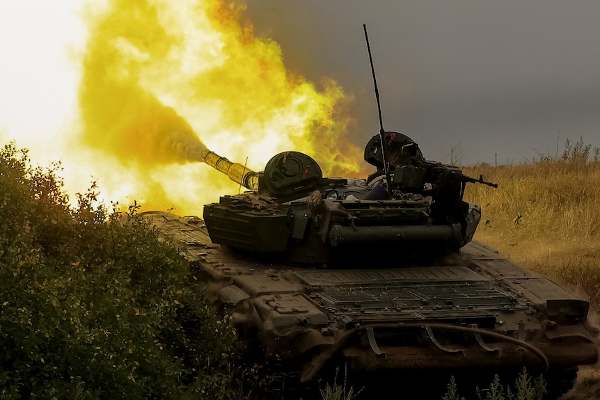 A green tank surrounded by fire.
