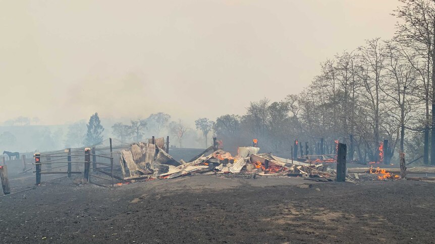 A farm shed still burning