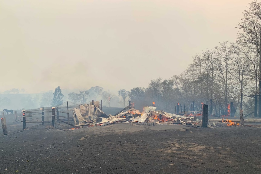A farm shed still burning.