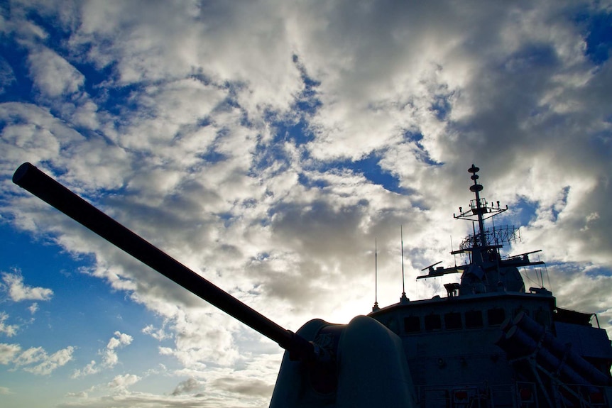 a warship shadow is seen against blue sky
