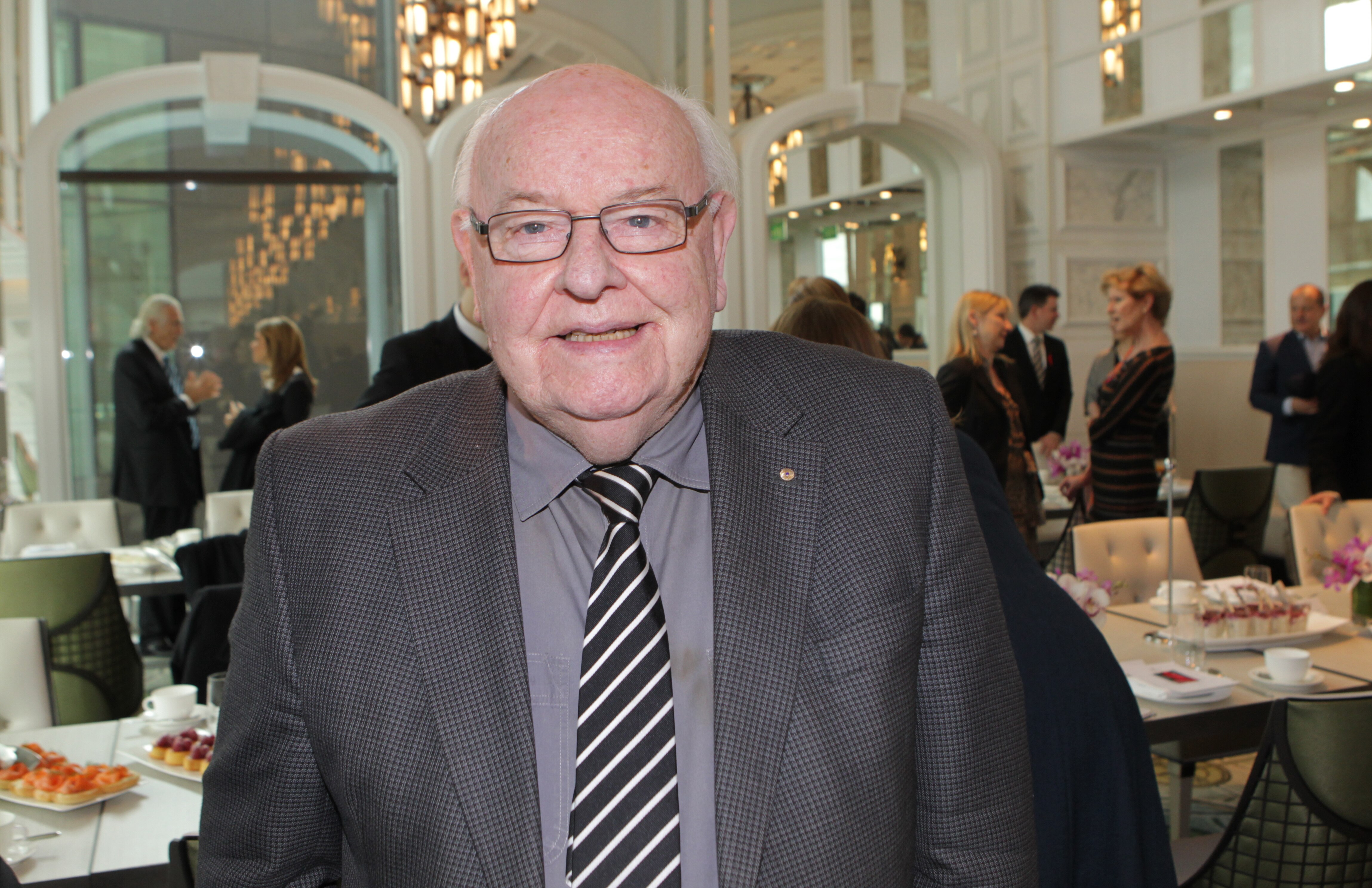 A man in a suit at a dinner function