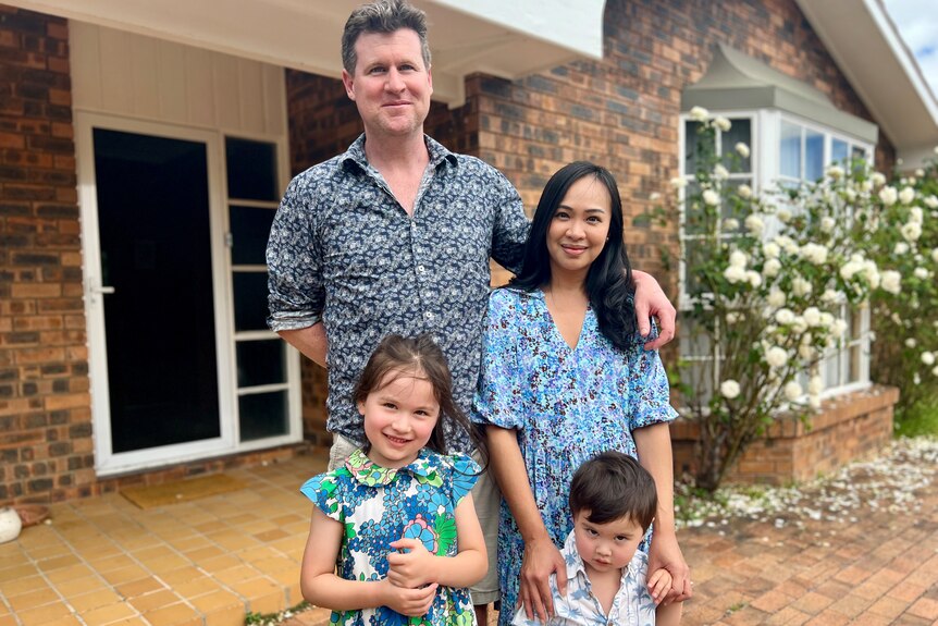 the roe family with dad andy, wife jo, daughter aria and son brendan stand in front of a new house after leaving sydney