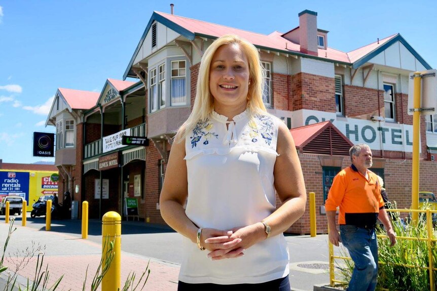 Kristie Johnston, the Glenorchy City Council Mayor, stands in front of a brick pub.