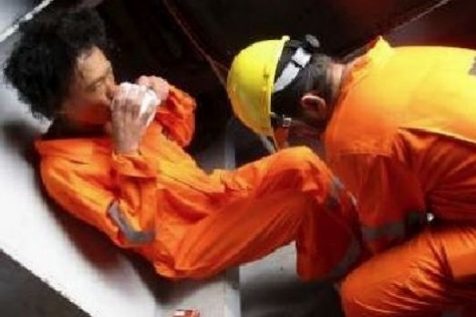 The rescued man sipping a drink in borrowed orange suit.