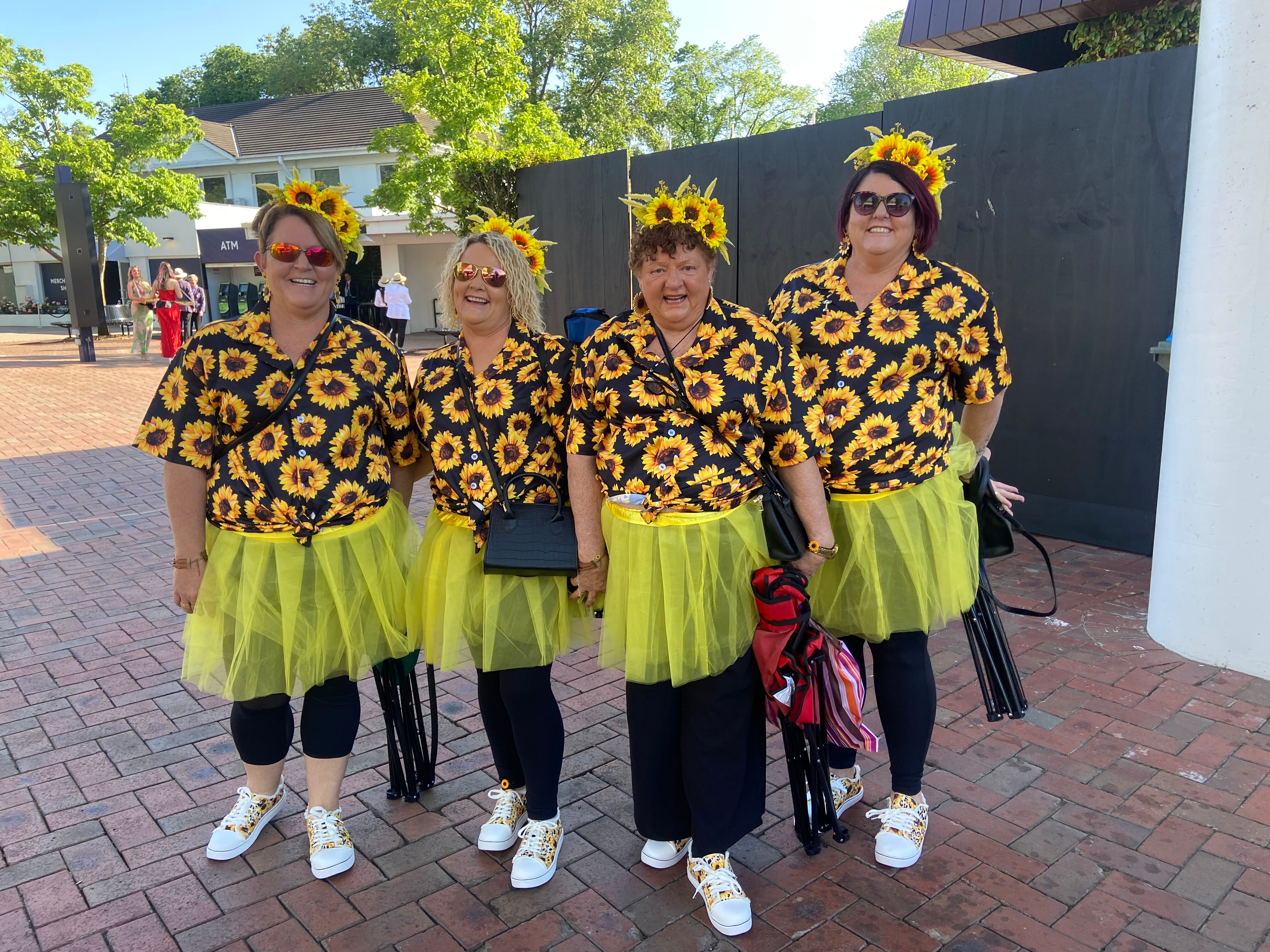 Four women in sunflower themed clothing