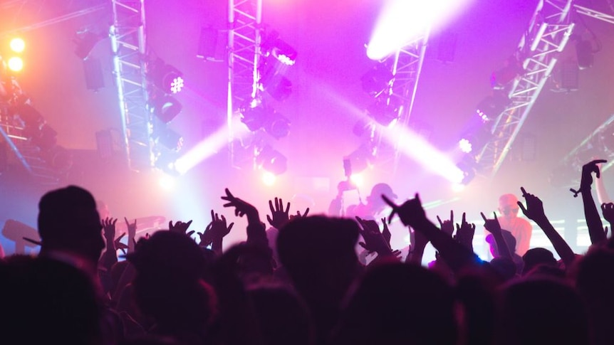 Schoolies partying outside in front of the event's main stage